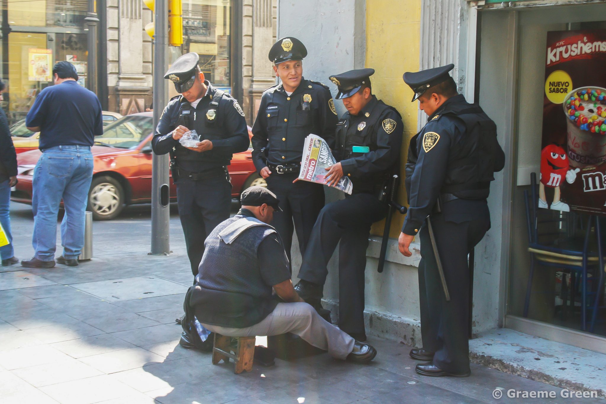 Policemen getting their shoes shined on the streets of Mexico City